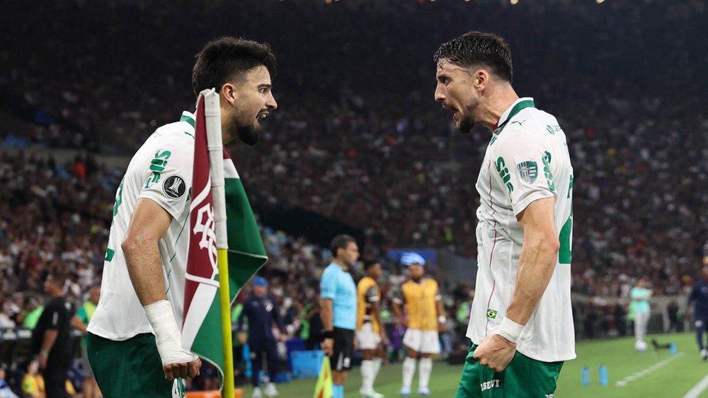 Flaco López e Piquerez, de camisa branca do Palmeiras, comemoram frente a frente junto à bandeirinha de escanteio do Maracanã