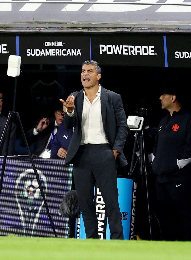 Pedro Emanuel, técnico do Vasco, de terno escuro e camisa clara, grita e gesticula à beira do gramado da Bombonera