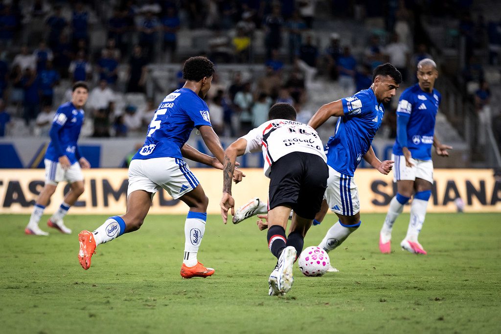 Zé Lucas, camisa 5 do Cruzeiro, acompanha a disputa de bola com jogador do São Paulo no Mineirão